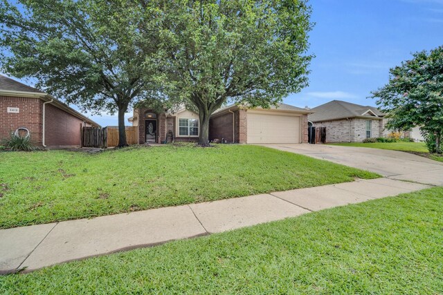 ranch-style home featuring a garage and a front lawn