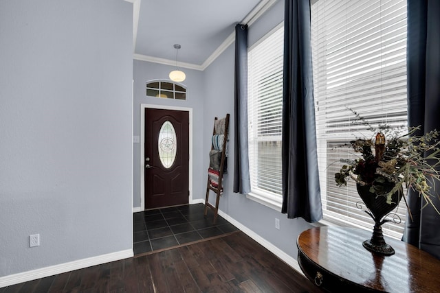 foyer entrance with dark hardwood / wood-style flooring and ornamental molding