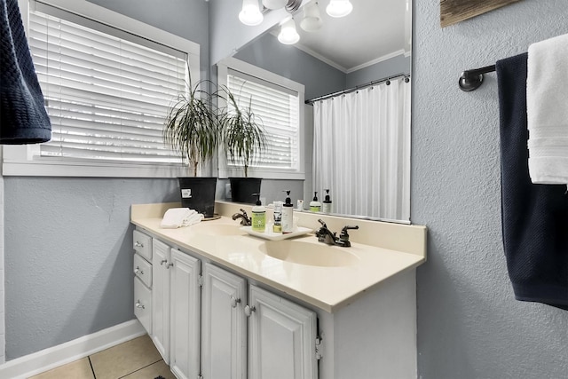 bathroom with crown molding, tile patterned flooring, and vanity