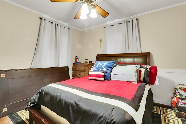 bedroom featuring ceiling fan, crown molding, and hardwood / wood-style floors