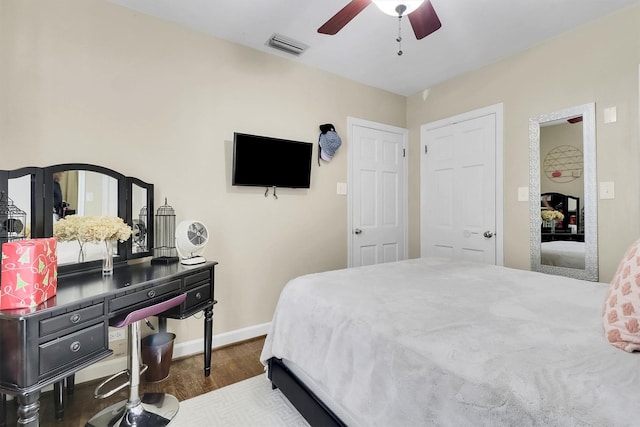 bedroom featuring ceiling fan and dark wood-type flooring