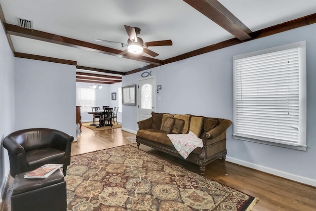 living room with wood-type flooring, ceiling fan, and beam ceiling