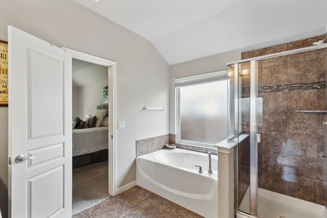 bathroom featuring plus walk in shower, tile patterned flooring, and lofted ceiling