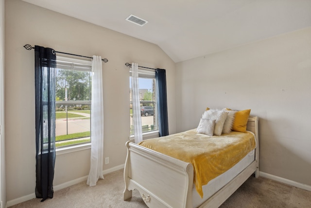 carpeted bedroom featuring lofted ceiling