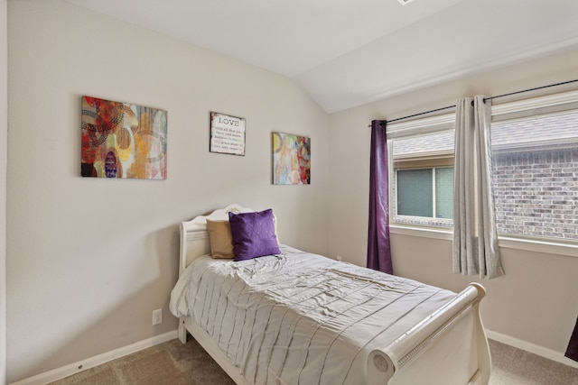 carpeted bedroom featuring vaulted ceiling