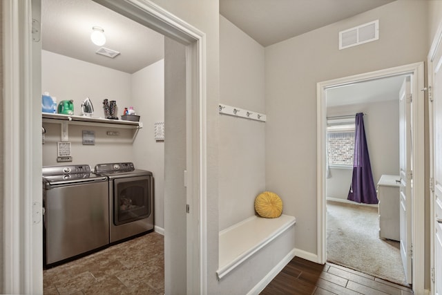 laundry room with dark hardwood / wood-style flooring and independent washer and dryer