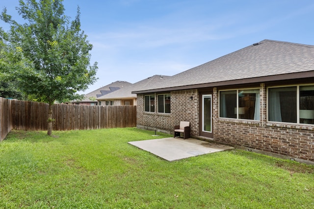 back of property featuring a lawn and a patio