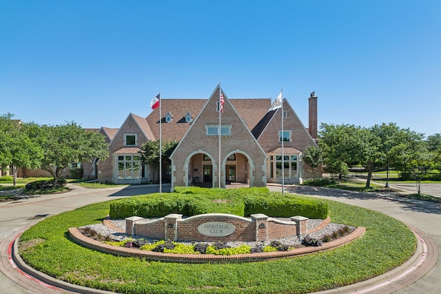 tudor home featuring a front yard