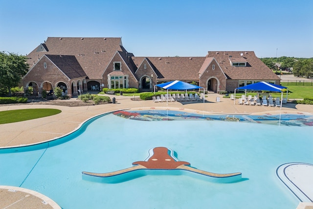 view of swimming pool featuring a patio and a gazebo