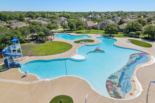 view of pool with a water slide and a patio area