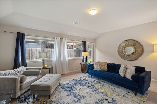 carpeted living room with lofted ceiling