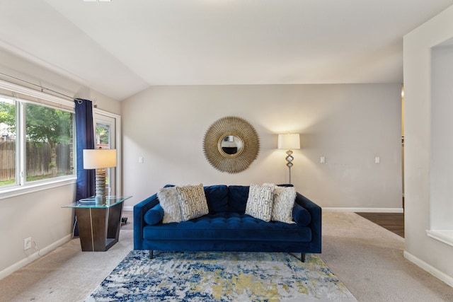 carpeted living room featuring lofted ceiling