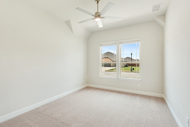 unfurnished room featuring lofted ceiling, ceiling fan, and light carpet