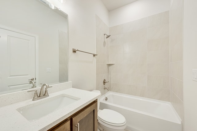 full bathroom featuring tiled shower / bath combo, vanity, and toilet