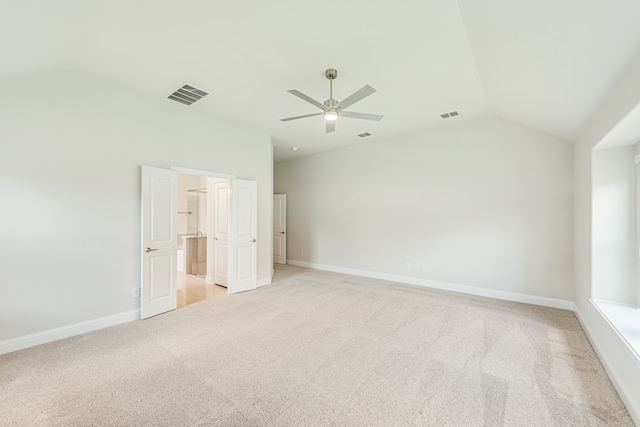 unfurnished bedroom with light colored carpet, ceiling fan, and vaulted ceiling