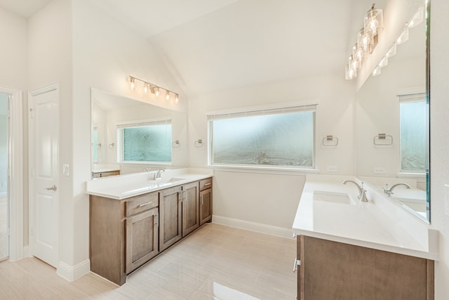 bathroom with lofted ceiling, vanity, and tile patterned flooring