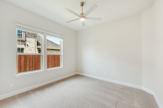 carpeted spare room with ceiling fan