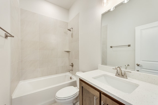 full bathroom with vanity, toilet, and tiled shower / bath combo