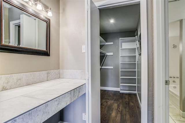 walk in closet featuring dark wood-type flooring