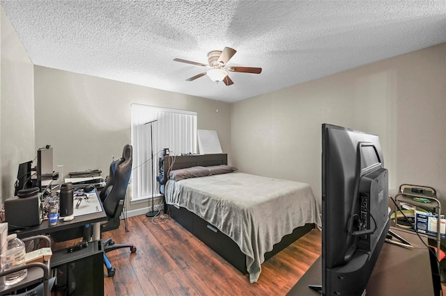 bedroom with dark hardwood / wood-style floors, a textured ceiling, and ceiling fan