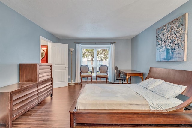 bedroom with dark hardwood / wood-style floors