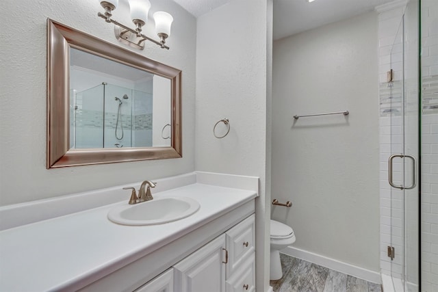 bathroom with hardwood / wood-style floors, vanity, toilet, and walk in shower