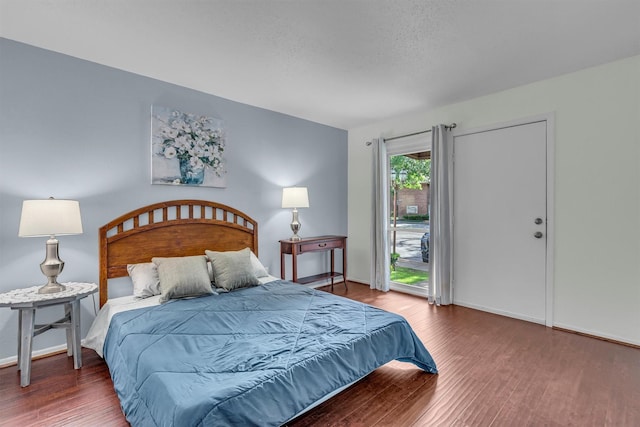 bedroom featuring hardwood / wood-style flooring and access to exterior