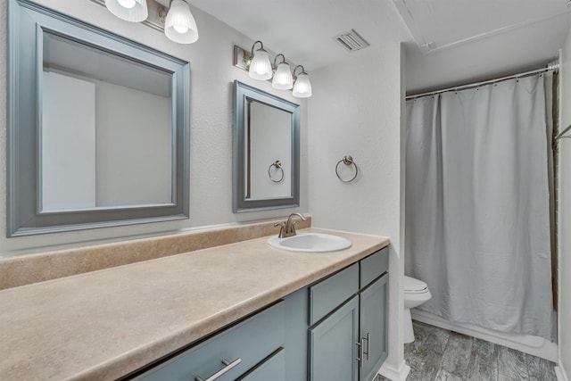 bathroom with hardwood / wood-style flooring, vanity, and toilet