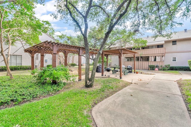 surrounding community featuring a pergola, a patio area, and a lawn