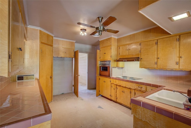 kitchen with tile counters, electric cooktop, ornamental molding, oven, and backsplash