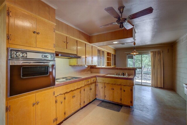 kitchen with oven, sink, wall chimney range hood, kitchen peninsula, and ceiling fan