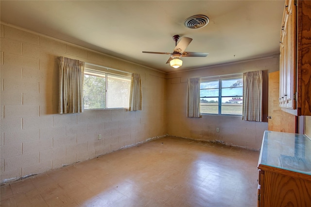 unfurnished room featuring ceiling fan, visible vents, a wealth of natural light, and tile patterned floors