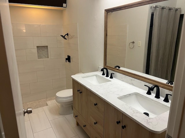 bathroom featuring tile patterned flooring, vanity, and toilet