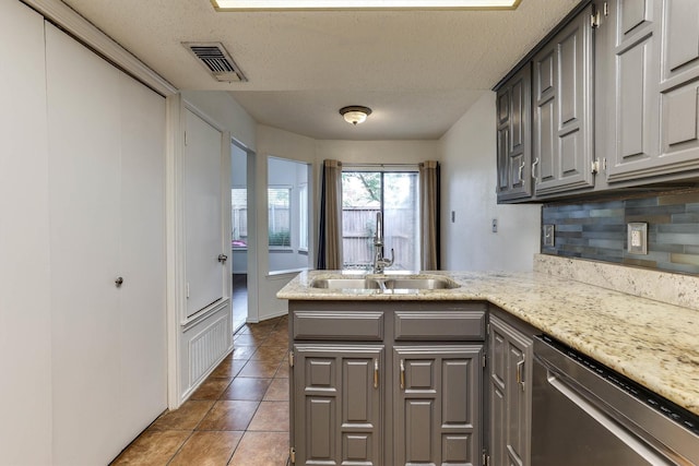 kitchen with dishwasher, sink, gray cabinets, a textured ceiling, and kitchen peninsula