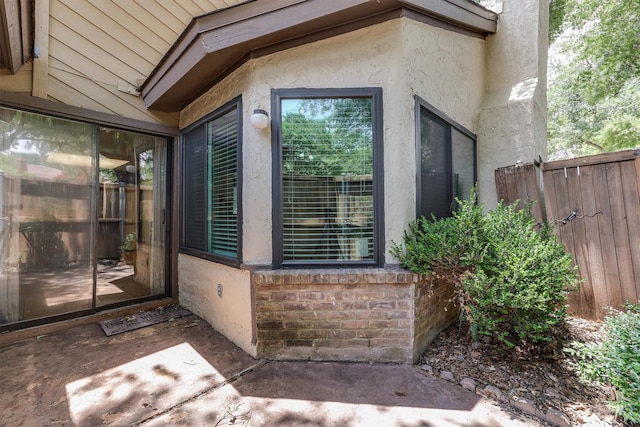 property entrance featuring a patio