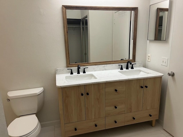 bathroom with tile patterned floors, vanity, and toilet