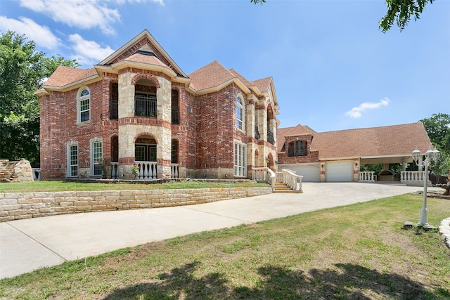 view of front of house with a garage and a front lawn