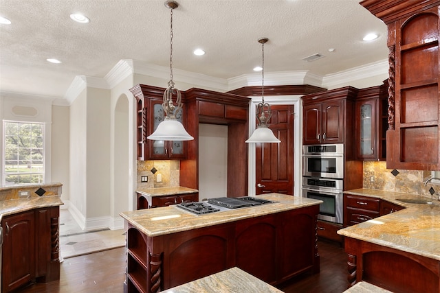 kitchen with dark hardwood / wood-style floors, tasteful backsplash, stainless steel appliances, a center island, and sink