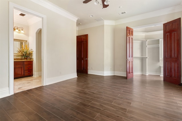 unfurnished room with crown molding, dark hardwood / wood-style floors, and ceiling fan