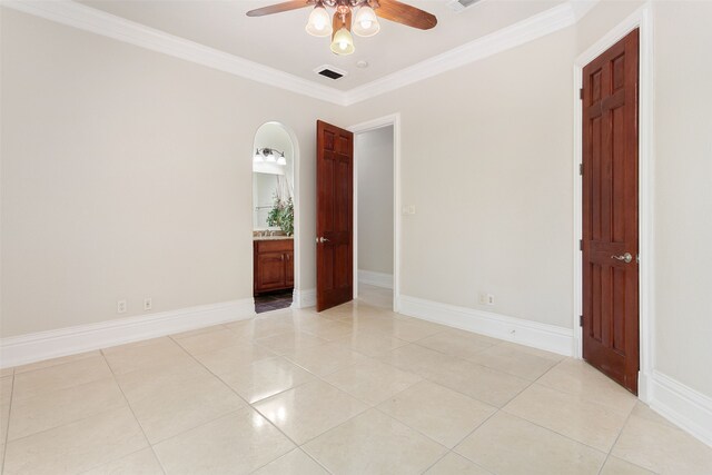 unfurnished room featuring ceiling fan, crown molding, and light tile floors