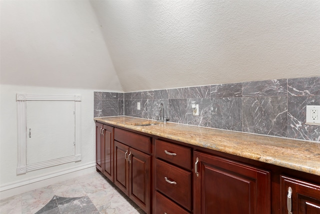 interior space featuring backsplash, sink, tile walls, and tile floors