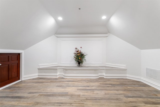 additional living space with lofted ceiling and wood-type flooring