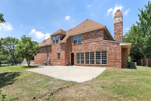 rear view of property with central AC, a lawn, and a patio