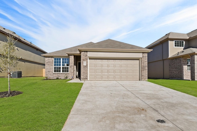 view of front of house featuring a front yard, brick siding, driveway, and an attached garage