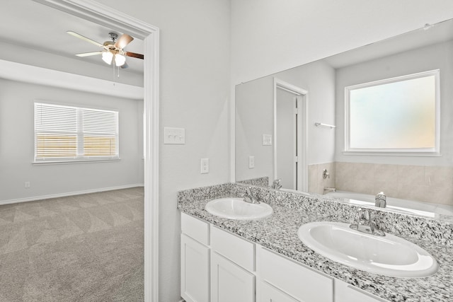 bathroom featuring a garden tub, a sink, baseboards, and double vanity