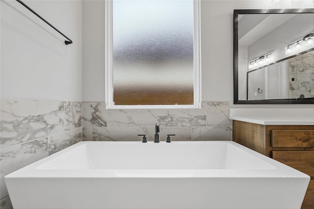 bathroom featuring a tub and vanity