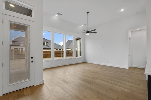 unfurnished living room featuring light wood-type flooring and ceiling fan