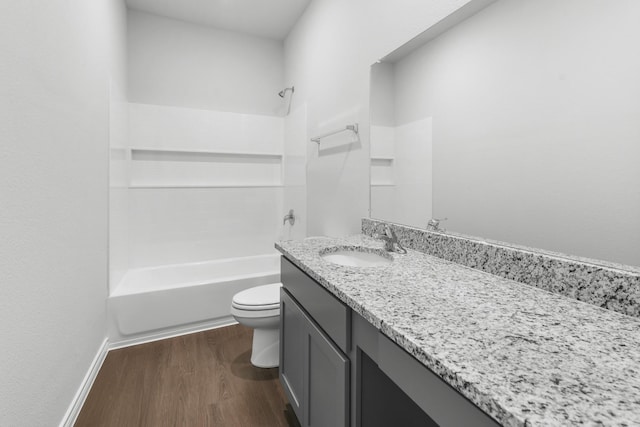 full bathroom featuring hardwood / wood-style floors, vanity,  shower combination, and toilet