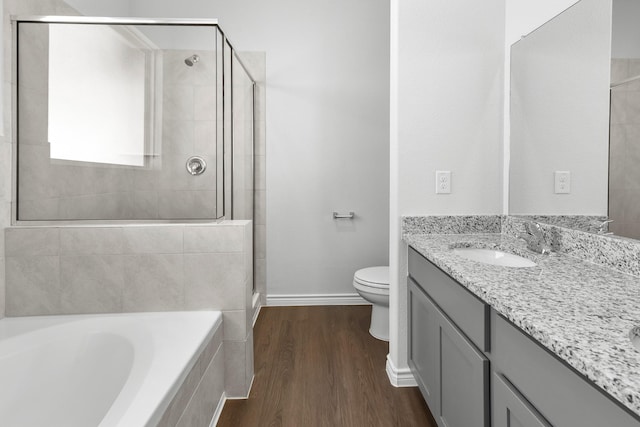 full bathroom featuring shower with separate bathtub, vanity, hardwood / wood-style flooring, and toilet