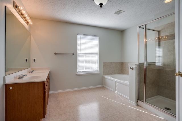 bathroom featuring tile floors, a textured ceiling, and vanity